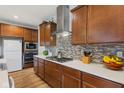 Well-lit kitchen featuring wooden cabinets, quartz countertops, and stainless steel appliances at 3948 Saddle Club S Pkwy, Bargersville, IN 46106