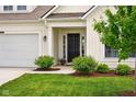 Welcoming front entrance with a stylish door, manicured bushes, and a neatly kept lawn at 4367 Homestead Dr, Whitestown, IN 46075