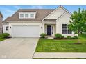 Inviting home showcasing a lush front lawn, attached garage, and a classic front door at 4367 Homestead Dr, Whitestown, IN 46075