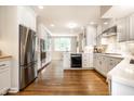 Bright, open kitchen with white cabinets, stainless steel appliances and hardwood floors at 4410 N Pennsylvania St, Indianapolis, IN 46205