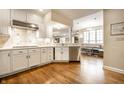 Bright, open kitchen with white cabinets, stainless steel appliances and hardwood floors at 4410 N Pennsylvania St, Indianapolis, IN 46205