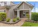 Inviting front porch featuring a small garden with a stone border leading to the front door at 4907 Franklin Villas Pl, Indianapolis, IN 46237