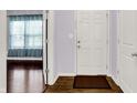 Inviting entryway with a white door and wood-look flooring at 5305 Adrian Orchard Dr, Indianapolis, IN 46217
