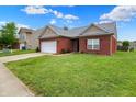 Beautiful single-story brick home featuring a lush green lawn at 5305 Adrian Orchard Dr, Indianapolis, IN 46217