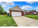 Well-maintained single-story brick home with attached two-car garage at 5305 Adrian Orchard Dr, Indianapolis, IN 46217
