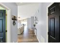 Inviting home hallway leading to a sunlit living space with hardwood floors and neutral decor at 5554 Jona Way, Bargersville, IN 46106