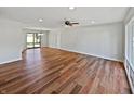 Spacious living area with hardwood flooring, ceiling fan, and natural light at 616 W Michigan St, Greenfield, IN 46140
