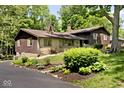 Exterior view of a home with stone accents and a well-maintained yard, enhancing curb appeal at 6248 Graham Rd, Indianapolis, IN 46220