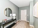 Welcoming entryway showcasing a stylish console table, modern mirror, and neutral decor at 6832 Oakcrest Dr, McCordsville, IN 46055