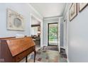 Welcoming entryway with slate floors, wood desk, and convenient coat closet at 7135 Huntington Rd, Indianapolis, IN 46240
