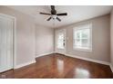 Bedroom featuring laminate floors, ceiling fan, a window, and a door leading to the backyard at 732 S Biltmore Ave, Indianapolis, IN 46241