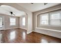 Inviting living room featuring gleaming hardwood floors, an archway, and abundant natural light streaming through the windows at 732 S Biltmore Ave, Indianapolis, IN 46241