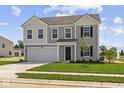 Charming two-story home with gray siding, a two-car garage, and a well-manicured lawn at 7323 Waylon Way, Indianapolis, IN 46239