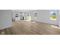 Open-concept living area featuring modern floors and an abundance of natural light at 7323 Waylon Way, Indianapolis, IN 46239