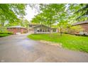 Charming two-story home with an inviting curb appeal, green lawn and mature trees at 806 Maplewood Ave, Anderson, IN 46012
