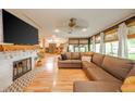 Open living room with a cozy fireplace, large TV, comfortable sofa, and seamless flow to dining at 806 Maplewood Ave, Anderson, IN 46012
