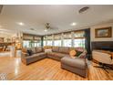 Spacious living room with hardwood floors, comfortable seating, a ceiling fan, and natural light at 806 Maplewood Ave, Anderson, IN 46012