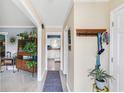 Inviting hallway with light-colored floors, coat rack, and a view into the living spaces filled with natural light at 9832 Scotch Pine Ln, Indianapolis, IN 46256