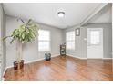Bright living room featuring hardwood floors, neutral paint, and lots of natural light at 10763 Zimmerman Ln, Indianapolis, IN 46231