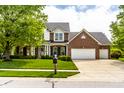 Charming two-story home with a manicured lawn, a three-car garage, and beautiful landscaping at 14805 Chamberlain Dr, Westfield, IN 46074