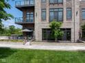 Stylish condominium with brick facade, glass balconies, and manicured landscaping at 15 W Executive Dr # 101, Carmel, IN 46032