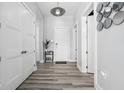 Bright hallway features hardwood floors, modern light fixtures, and white doors at 15 W Executive Dr # 101, Carmel, IN 46032