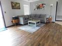 Inviting living room featuring hardwood floors, a comfortable sectional sofa, and stylish decor at 1612 Prairieview Ln, Greenfield, IN 46140