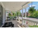 Comfortable front porch area with seating, hanging plants, and views of the neighborhood at 1616 N Delaware St, Indianapolis, IN 46202