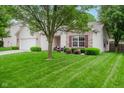 Lovely single-story home with a well-maintained lawn, attached garage, and cozy front seating area at 16768 Maraschino Dr, Noblesville, IN 46062