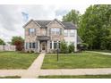 Inviting two-story home featuring a brick facade, well-maintained lawn, and established landscaping at 1680 Arbor Springs Dr, Brownsburg, IN 46112