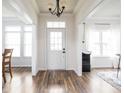 Bright foyer with dark wood floors, white trim and natural light at 1680 Arbor Springs Dr, Brownsburg, IN 46112