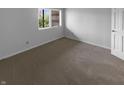 Simple bedroom with neutral carpet, white walls, and a window offering natural light at 1726 Creekside W Ln, Carmel, IN 46032