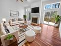 Bright living room features hardwood floors, a fireplace, and access to an outdoor deck at 1726 Creekside W Ln, Carmel, IN 46032