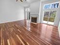 Spacious living room features hardwood floors, a fireplace, and access to an outdoor deck at 1726 Creekside W Ln, Carmel, IN 46032