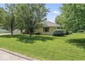 Well-maintained home features mature trees, a lush lawn, and desirable neighborhood at 1817 Edgewood Dr, Anderson, IN 46011