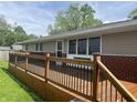 Wooden deck with black metal railings, offering outdoor space and curb appeal to the home at 1927 E 125 S, Franklin, IN 46131