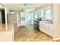 Modern kitchen with stainless steel appliances, white cabinets, and neutral backsplash at 1927 E 125 S, Franklin, IN 46131