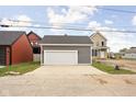 Detached two-car garage with a large concrete driveway and modern design at 2024 Yandes St, Indianapolis, IN 46202