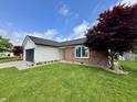 Well-kept home with a lush lawn and decorative trees providing beautiful curb appeal at 204 Meadow Creek S Dr, Whiteland, IN 46184