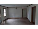 Spacious living room with neutral walls and natural light, ready for personalized updates at 2100 N Janney Ave, Muncie, IN 47304