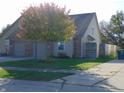 Charming home featuring a two-car garage, brick accents, and a well-manicured lawn with mature tree at 2116 Galaxy Dr, Franklin, IN 46131