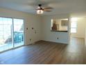 Bright living room with wood floors, a ceiling fan and sliding glass doors leading to the patio at 2116 Galaxy Dr, Franklin, IN 46131