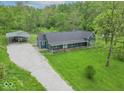 Expansive property featuring a well-maintained lawn, outbuilding, and gravel driveway, offering ample space and privacy at 2935 N Grizzly Ln, Martinsville, IN 46151