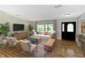 Inviting living room featuring hardwood floors, a comfortable sofa, and an abundance of natural light, creating a cozy atmosphere at 2935 N Grizzly Ln, Martinsville, IN 46151