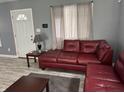 Cozy living room with modern gray paint, light-colored floors, and a comfortable leather couch at 322 S Rural St, Indianapolis, IN 46201