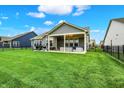 Exterior showcases a home's backyard with a patio area, outdoor seating, and a well-maintained lawn at 3592 Gillsland Rd, Bargersville, IN 46106