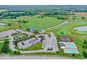 Expansive aerial view of lush golf course, clubhouse, pool, and tennis courts at 3832 Boundary Bay Dr, Indianapolis, IN 46217