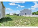 A spacious backyard of a house with green lawn under a sunny sky at 3832 Boundary Bay Dr, Indianapolis, IN 46217