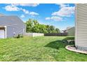 A spacious backyard with healthy green grass and wooden fence at 3832 Boundary Bay Dr, Indianapolis, IN 46217