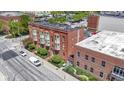 Brick apartment building with bay windows, professional landscaping, and a view of the city at 404 E New York E St # 406, Indianapolis, IN 46202